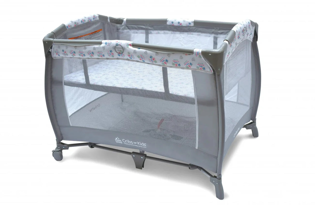 Gray portable play yard crib with mesh sides and patterned trim on a white background