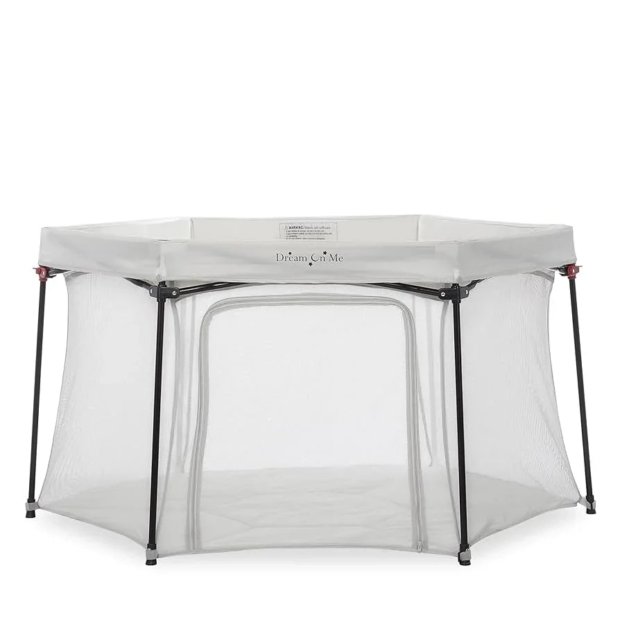 Dream On Me white portable baby playpen with mesh sides and zippered front opening
