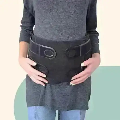 Front view of Matriarch pregnancy support belt size L/XL on model showing wide elastic wrap and Velcro closures