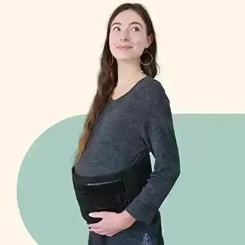 Side view of Matriarch pregnancy support belt in black worn by pregnant model, showing adjustable front closure