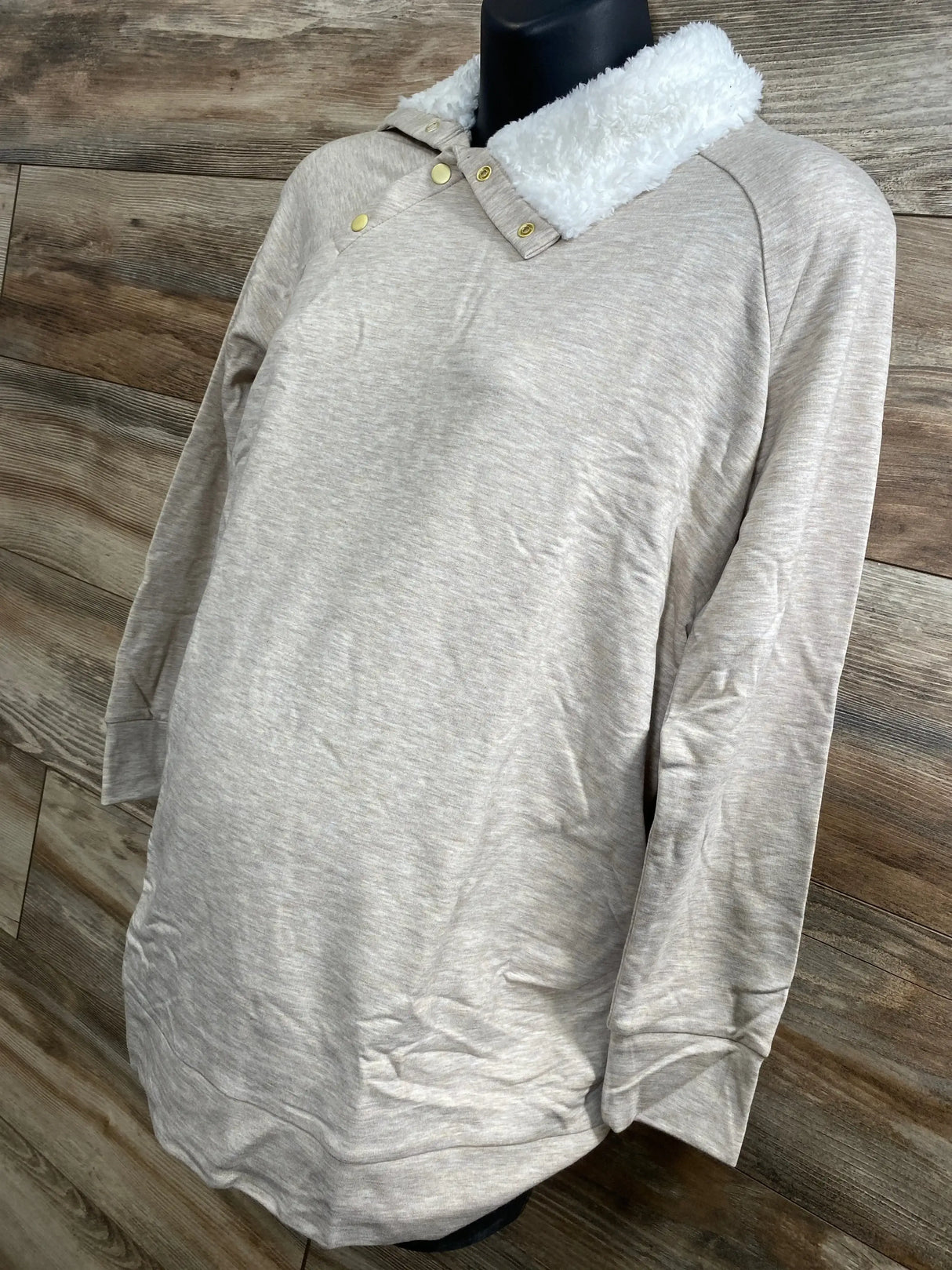 Three-quarter view of Isabel maternity oatmeal sweatshirt showing sherpa snap collar and long sleeves, wood plank backdrop