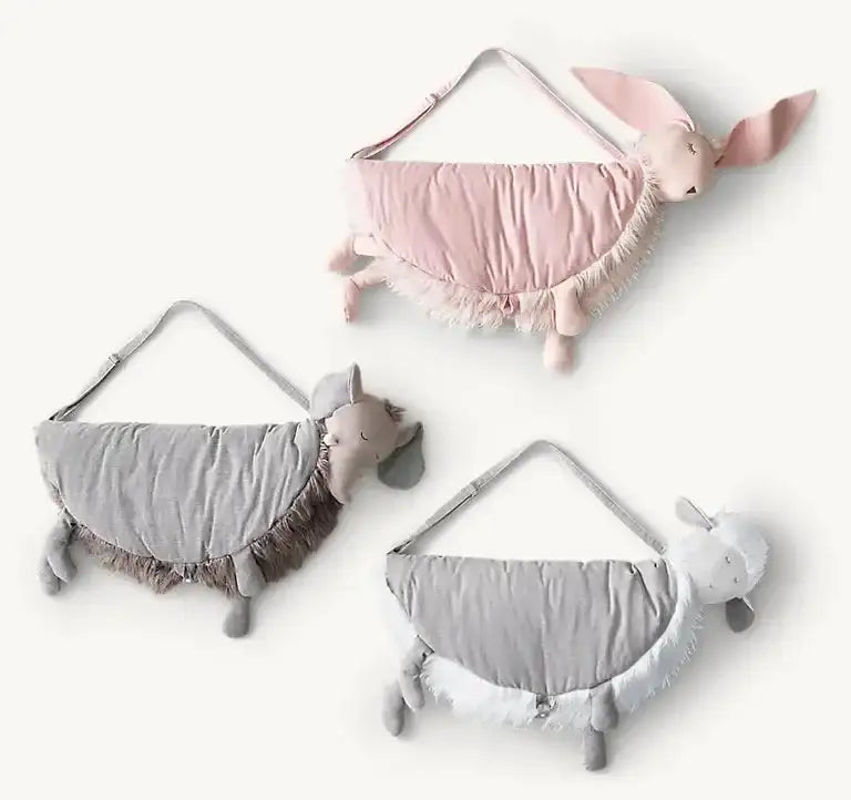 Flat lay of three Petal Bunny plush play mats showing bunny-shaped half-moon, straps, and furry trim on pale background