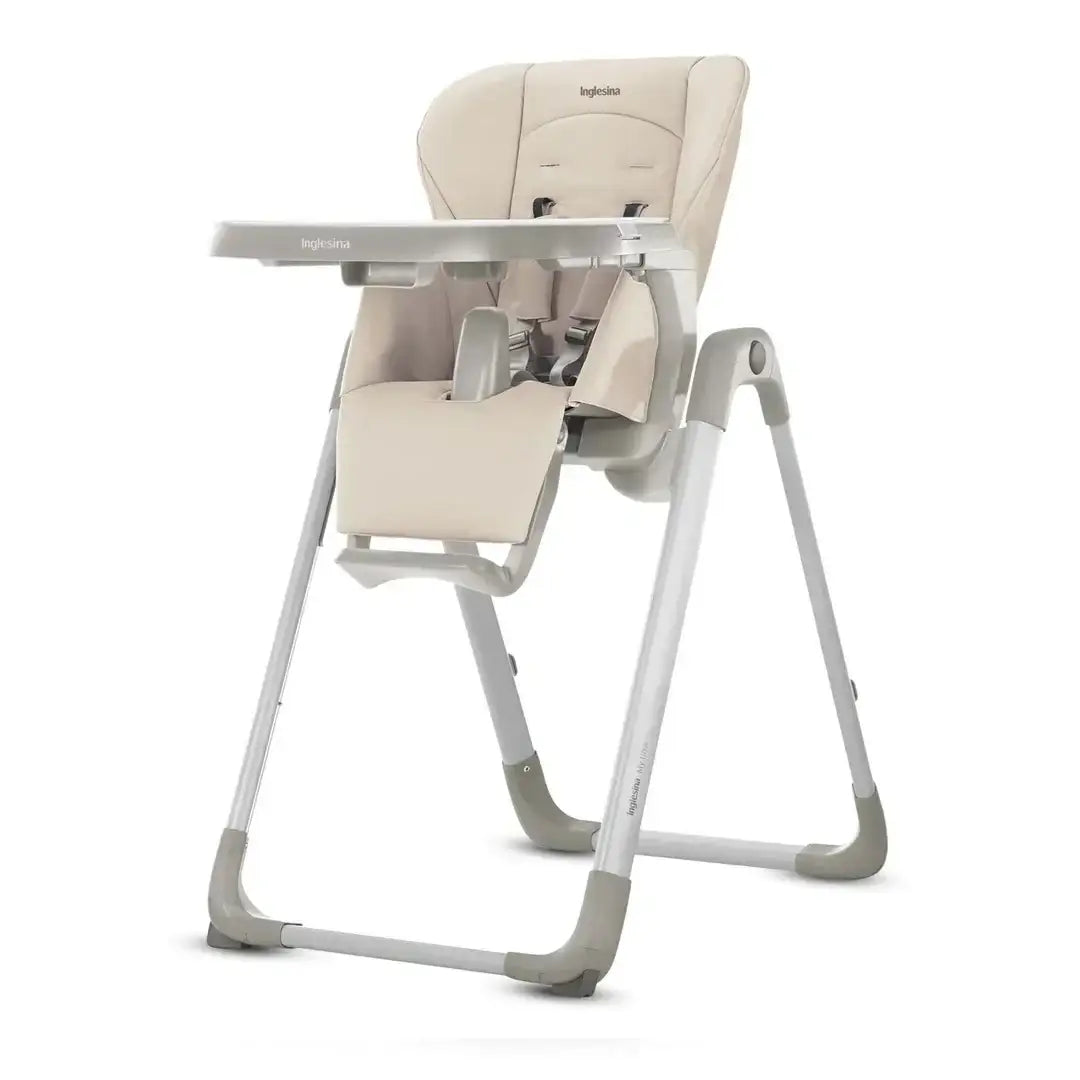 Inglesina beige baby high chair with adjustable tray, safety harness, and footrest on white frame