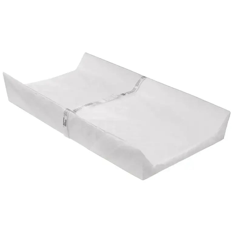 White contoured baby changing pad with safety strap for nursery diaper changes