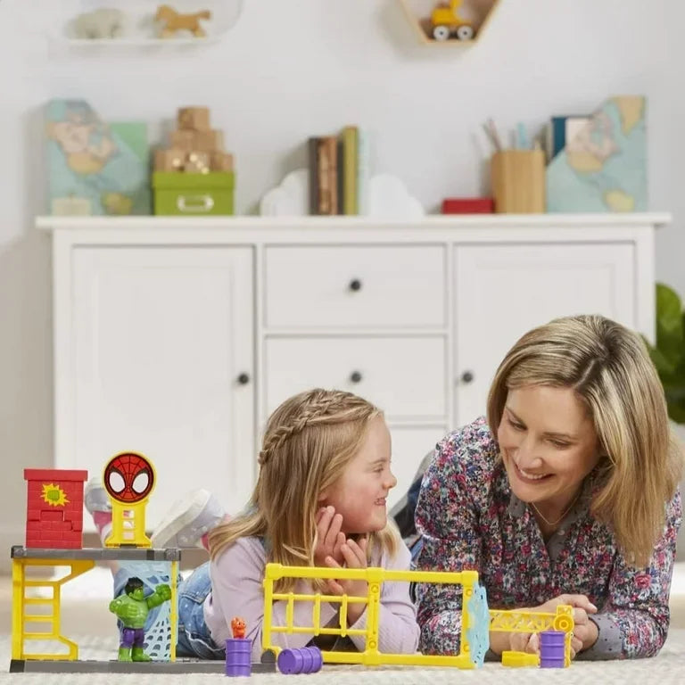Mother and daughter playing with superhero building toy set in kids room
