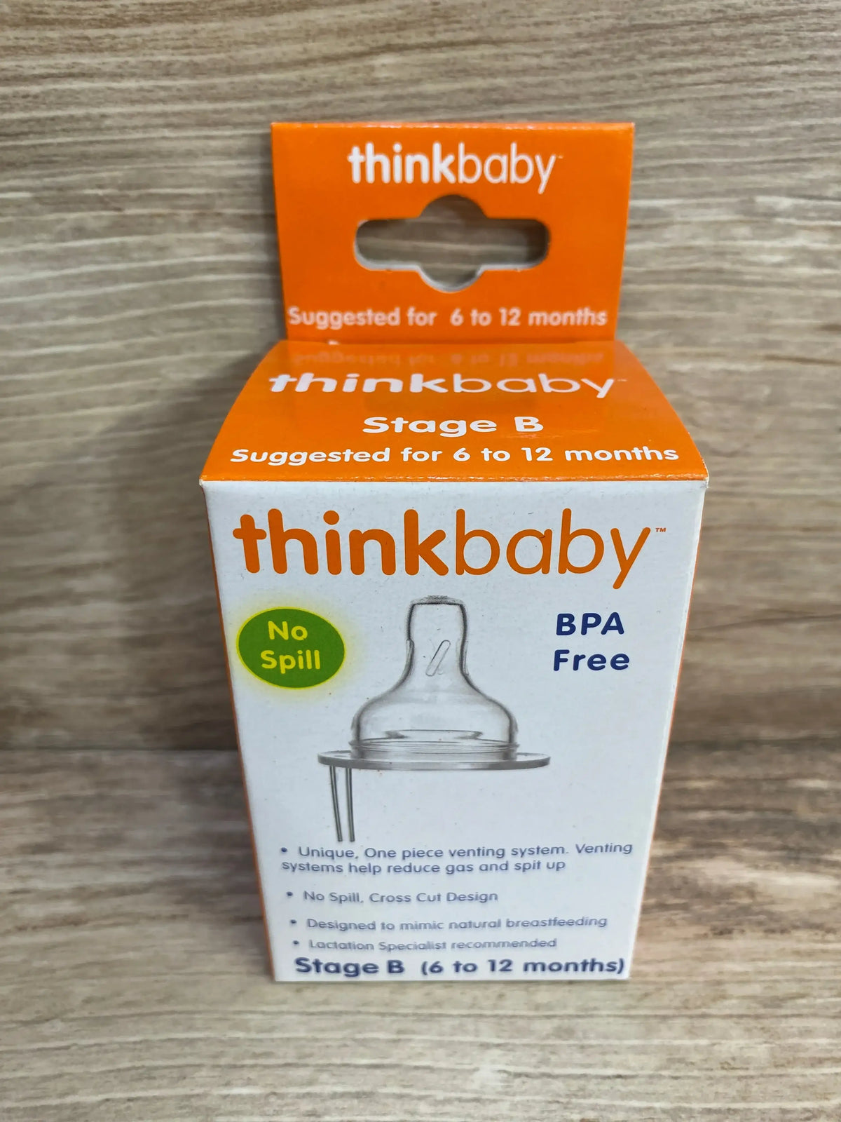 Front view of thinkbaby Stage B nipples packaging showcasing venting nipple illustration and No Spill badge with wood background