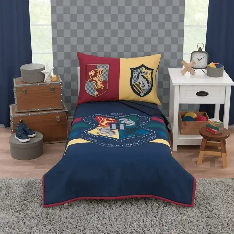 Front view of NoJo Harry Potter 4-piece toddler bedding set showing comforter with Hogwarts crest and matching sheets on a white toddler bed