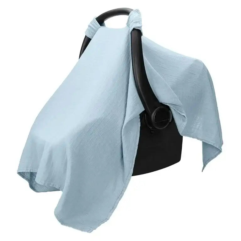 Three-quarter view of Comfy Cubs muslin car seat cover in light blue draped over infant carrier on white background