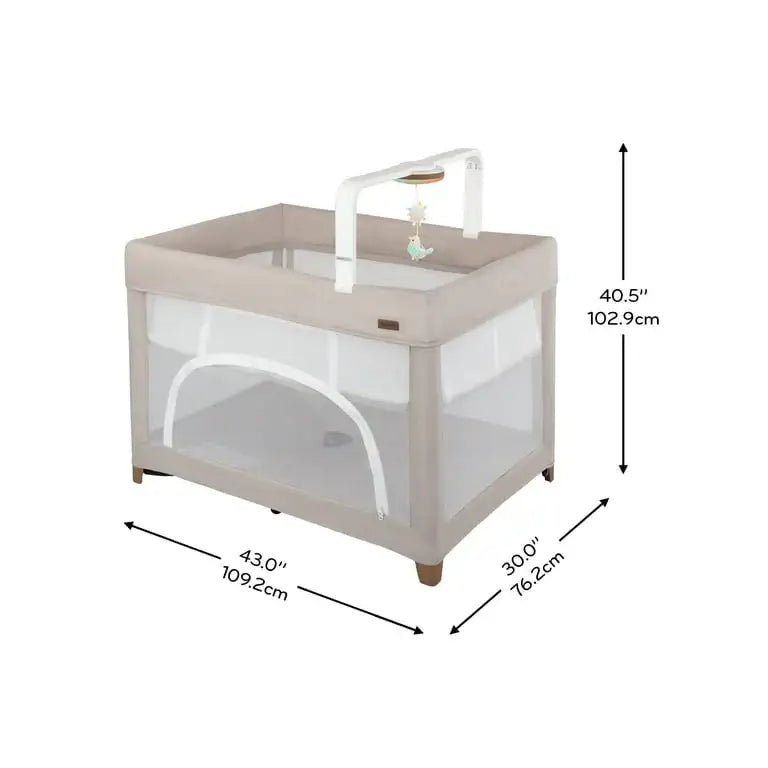Three-quarter view of Evenflo Eris One-Hand Playard with Bassinet showcasing toy bar, 43 by 30 by 40.5 inches