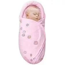 Front view of Knirose baby swaddle blanket in Button PeachPink with a sleeping baby and printed pattern on a white background