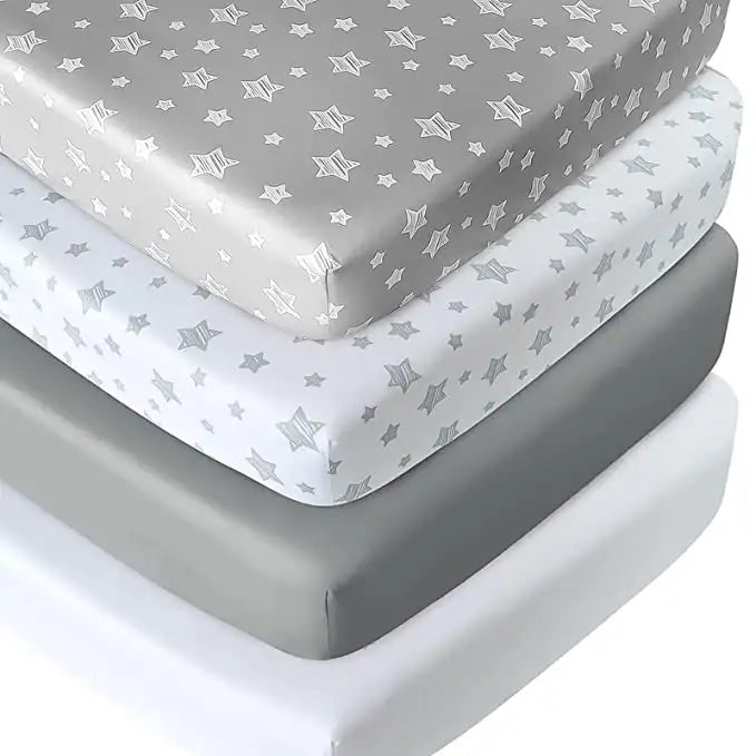 Close-up of four Moonsea crib sheets showcasing gray and white star patterns stacked on a white background