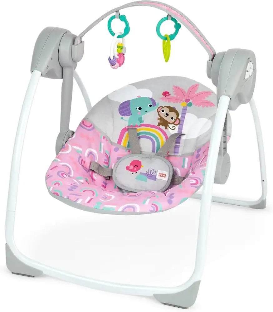 Front view of Bright Starts Pink Paradise swing with pink patterned seat, hanging toys, and harness on white