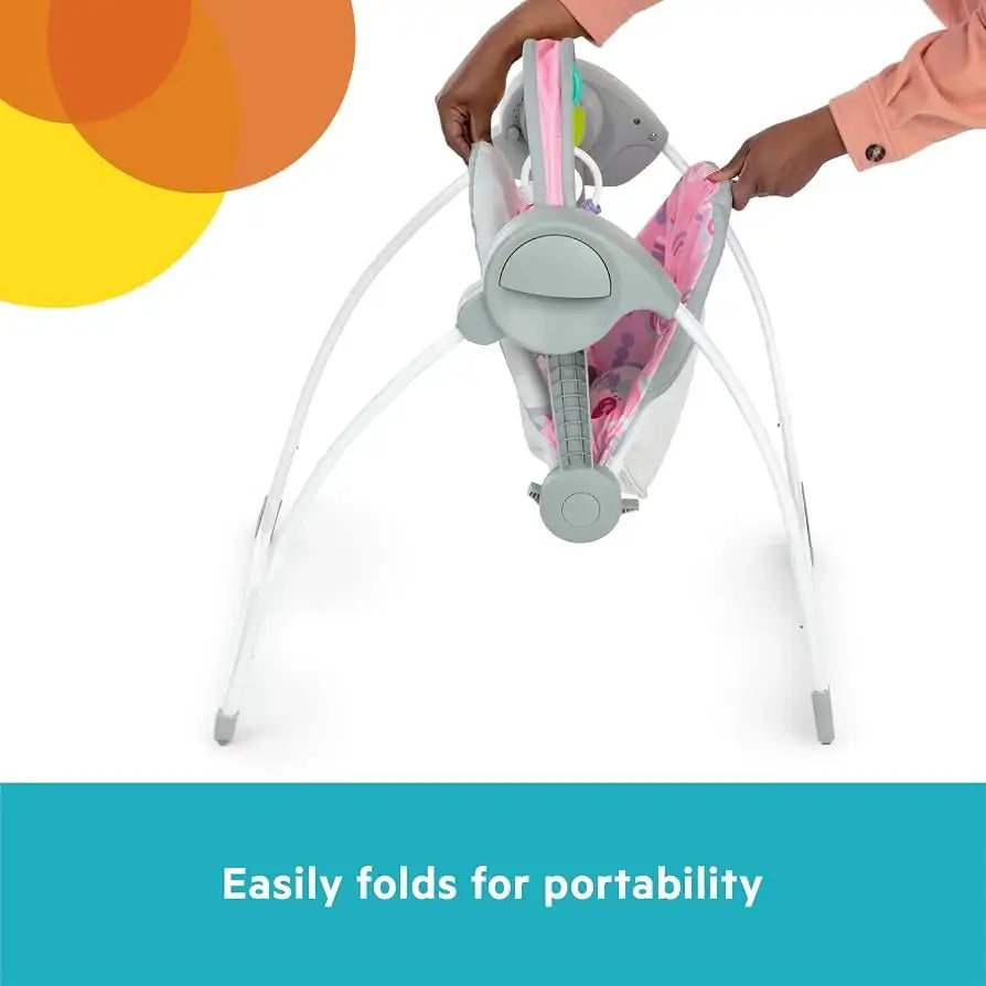 Front view of NEW Bright Starts Pink Paradise Portable Swing showcasing easy folding for portability against a white background
