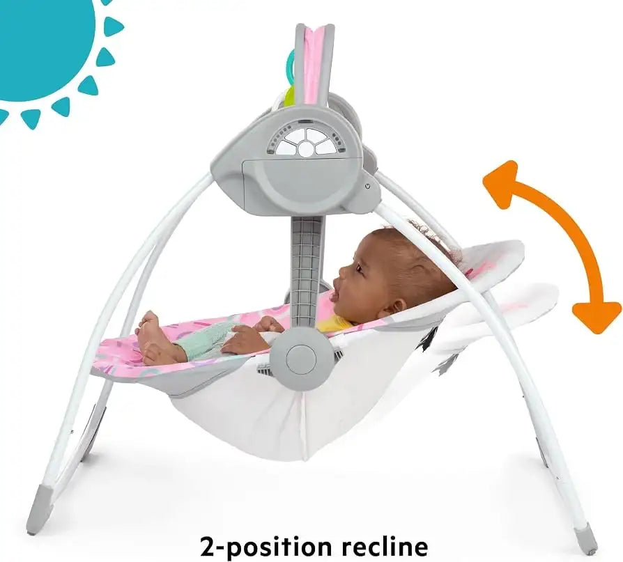 Front view of Bright Starts Pink Paradise portable swing showcasing two-position recline with a baby on a white background
