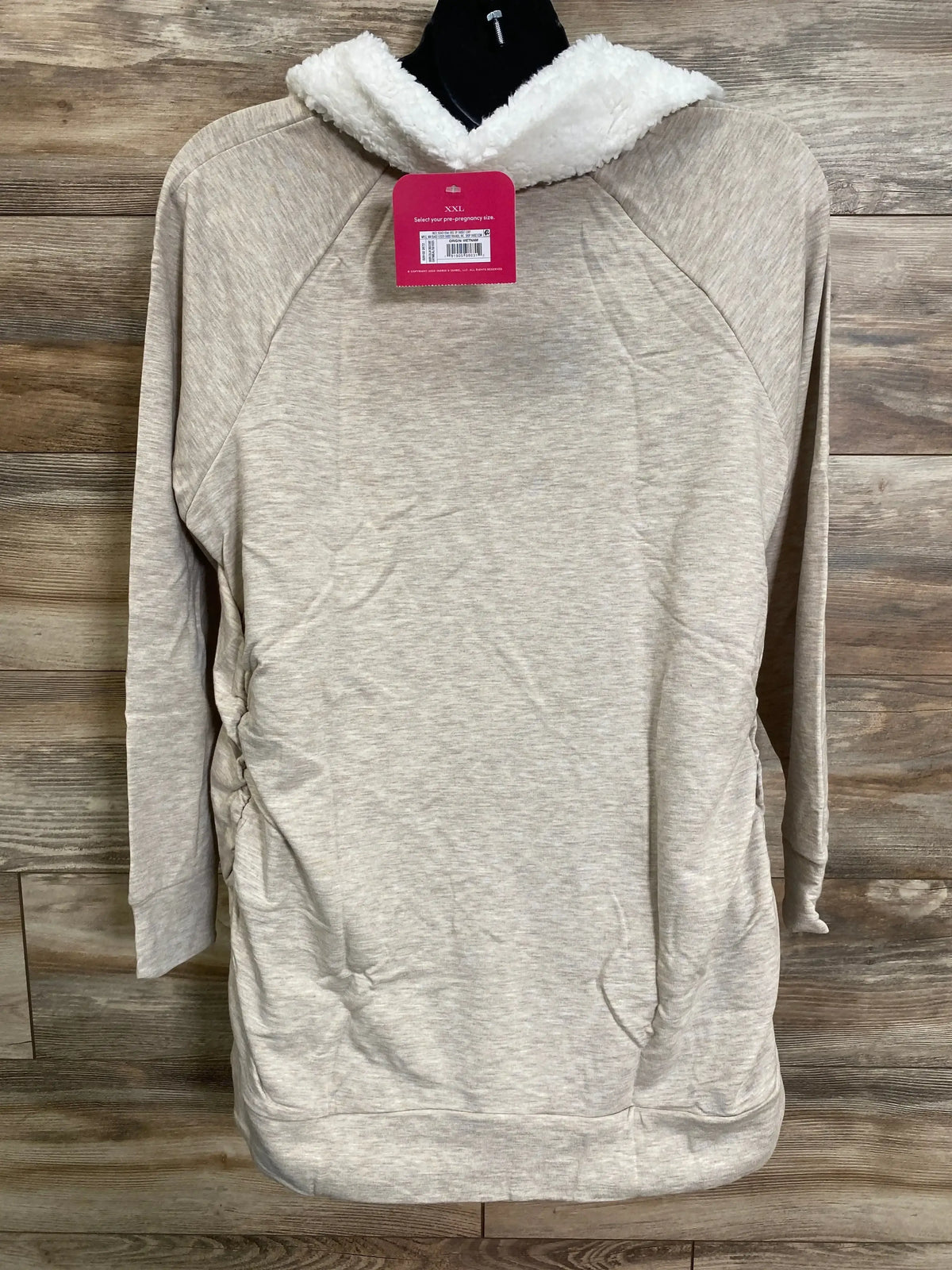 Front view of Isabel maternity sweatshirt in oatmeal with white sherpa collar and side ruching for maternity fit on wood background
