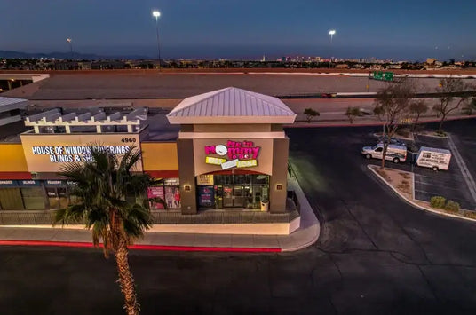 Me n Mommy To Be storefront at dusk in a Las Vegas strip mall with illuminated sign and parking lot