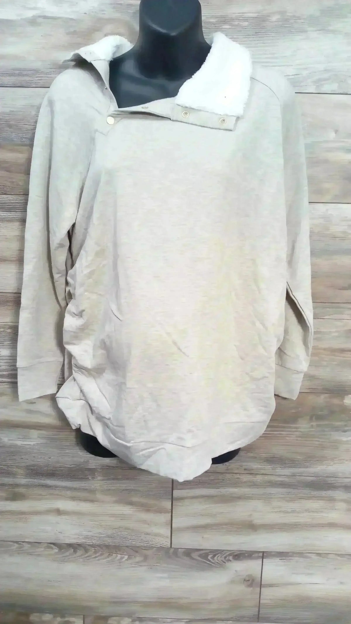 Front view of Isabel maternity oatmeal sweatshirt showcasing snap sherpa collar and ruched sides on wood background