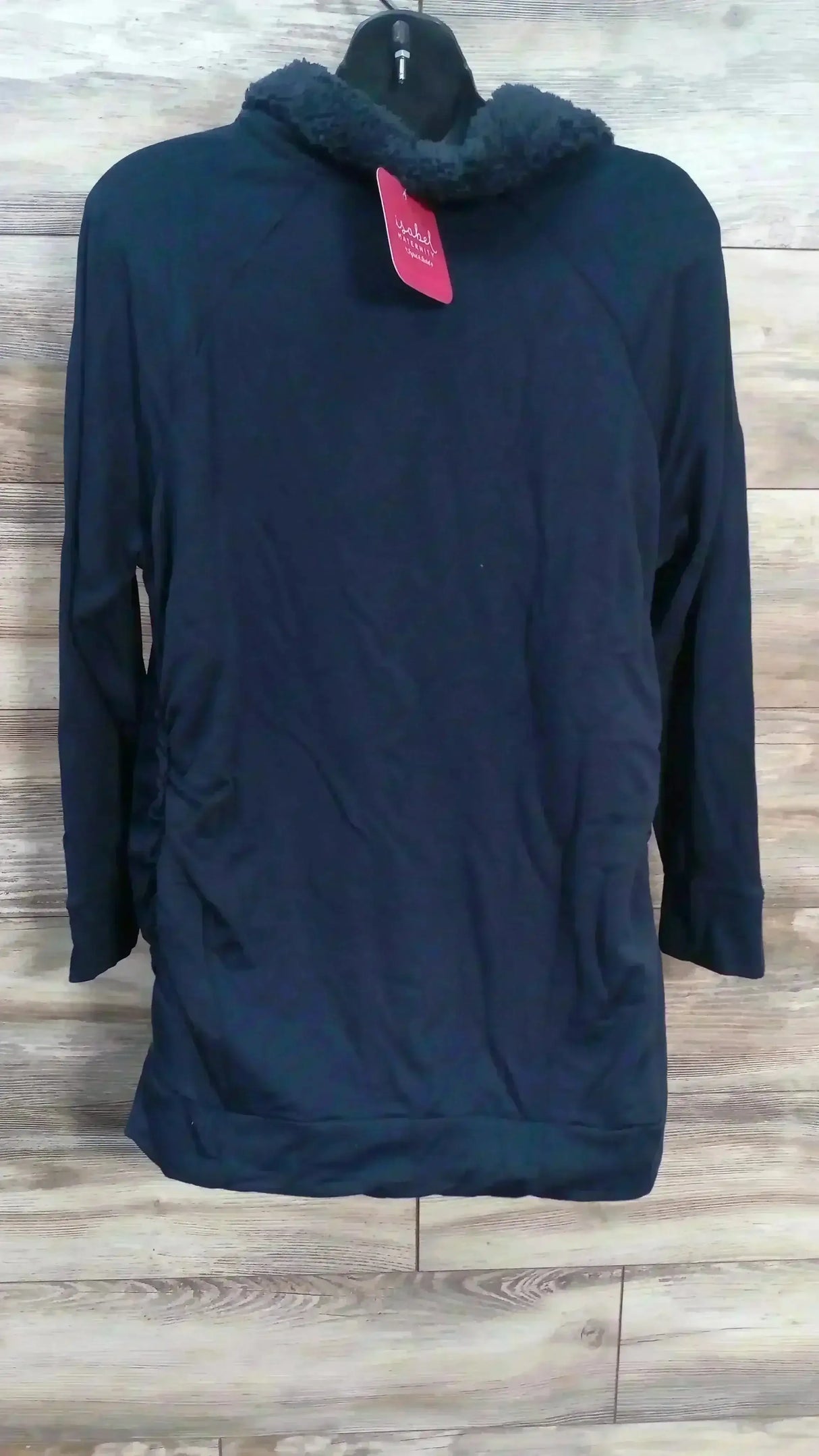 Front view of Isabel maternity navy sweatshirt showcasing sherpa snap collar and side ruching on wood plank background