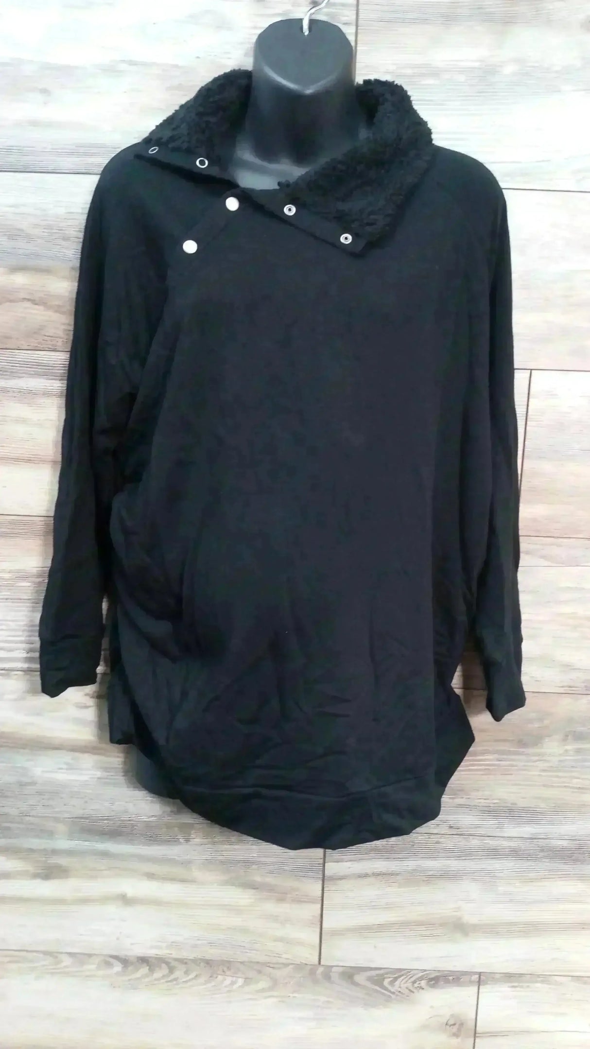 Front view of NEW Isabel Maternity Snap Sherpa Collar Sweatshirt black sz XL showcasing snap placket on hanger on wood floor