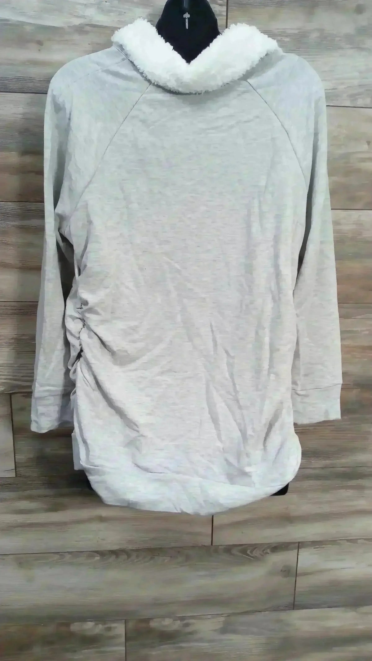 Back view of NEW Isabel Maternity Snap Sherpa Collar Grey Sweatshirt with ruched side panels on mannequin sz XXL on wood plank floor