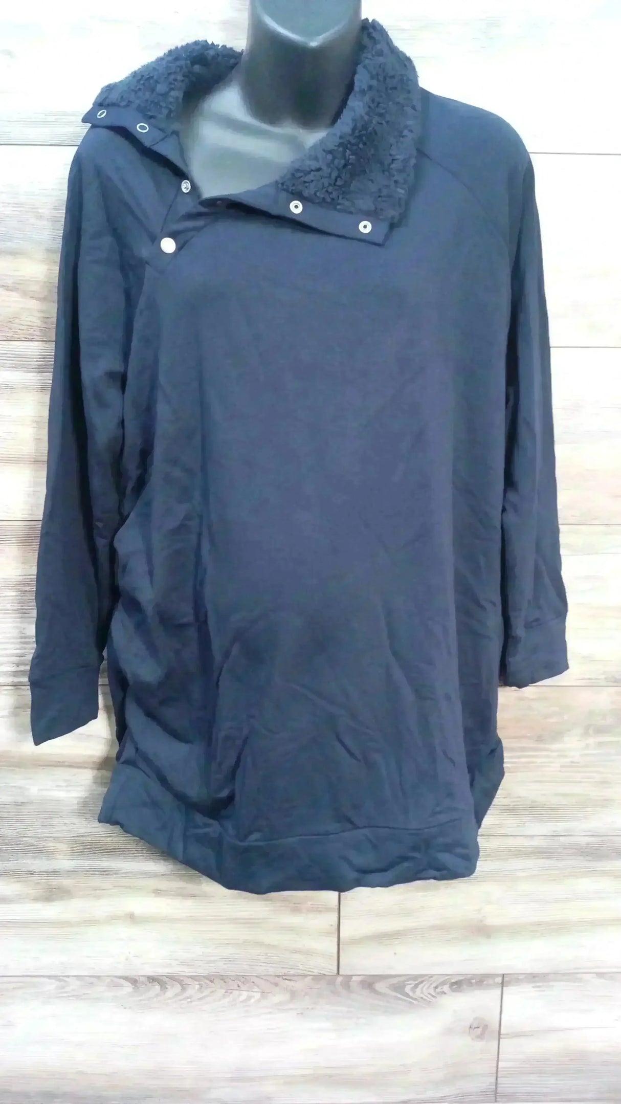 Front view of Isabel maternity navy sweatshirt showing snap sherpa collar and long sleeves on mannequin against wood background