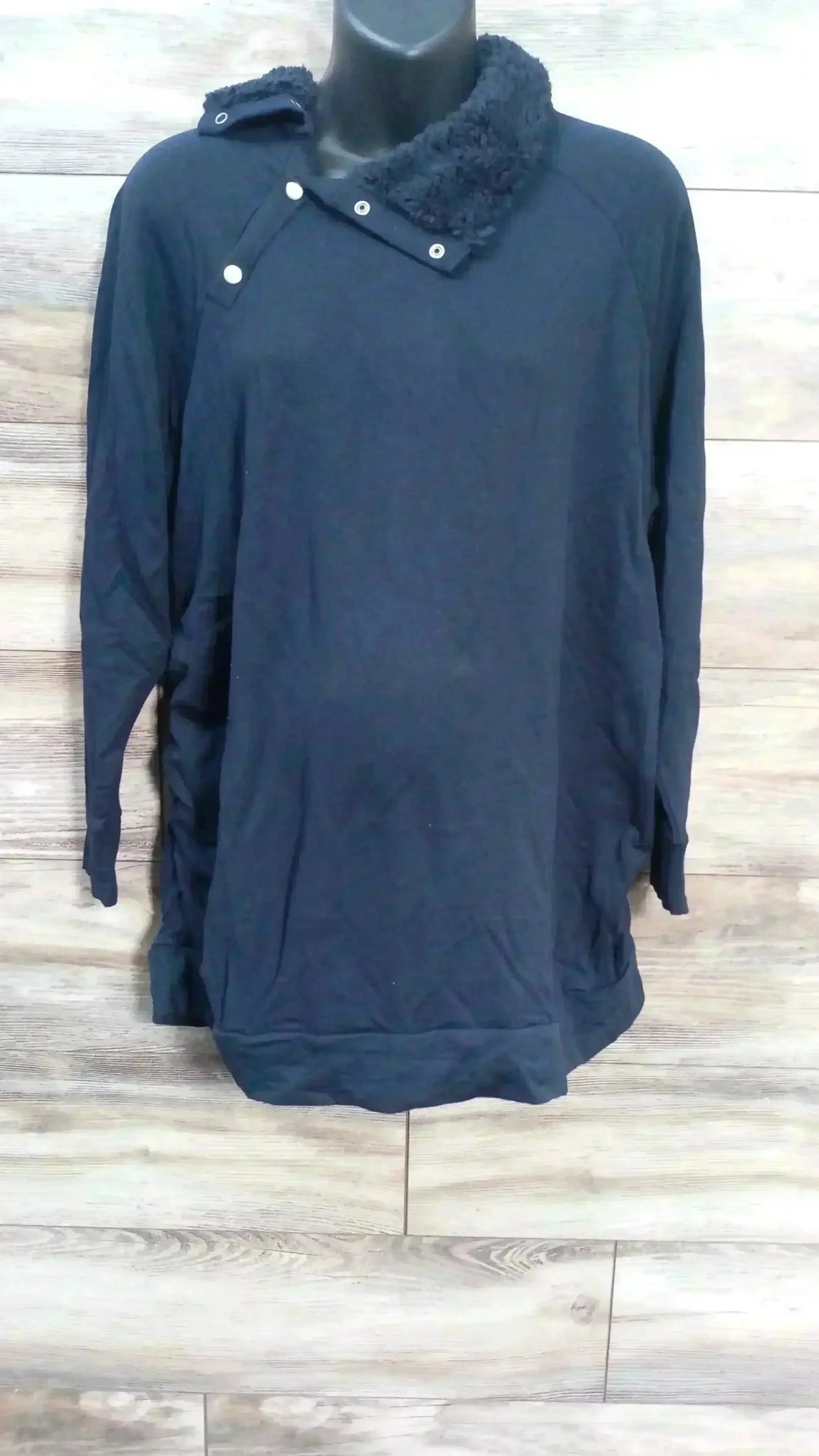 Front view of Isabel maternity navy sweatshirt (XXL) showing snap-button sherpa collar on wood plank background