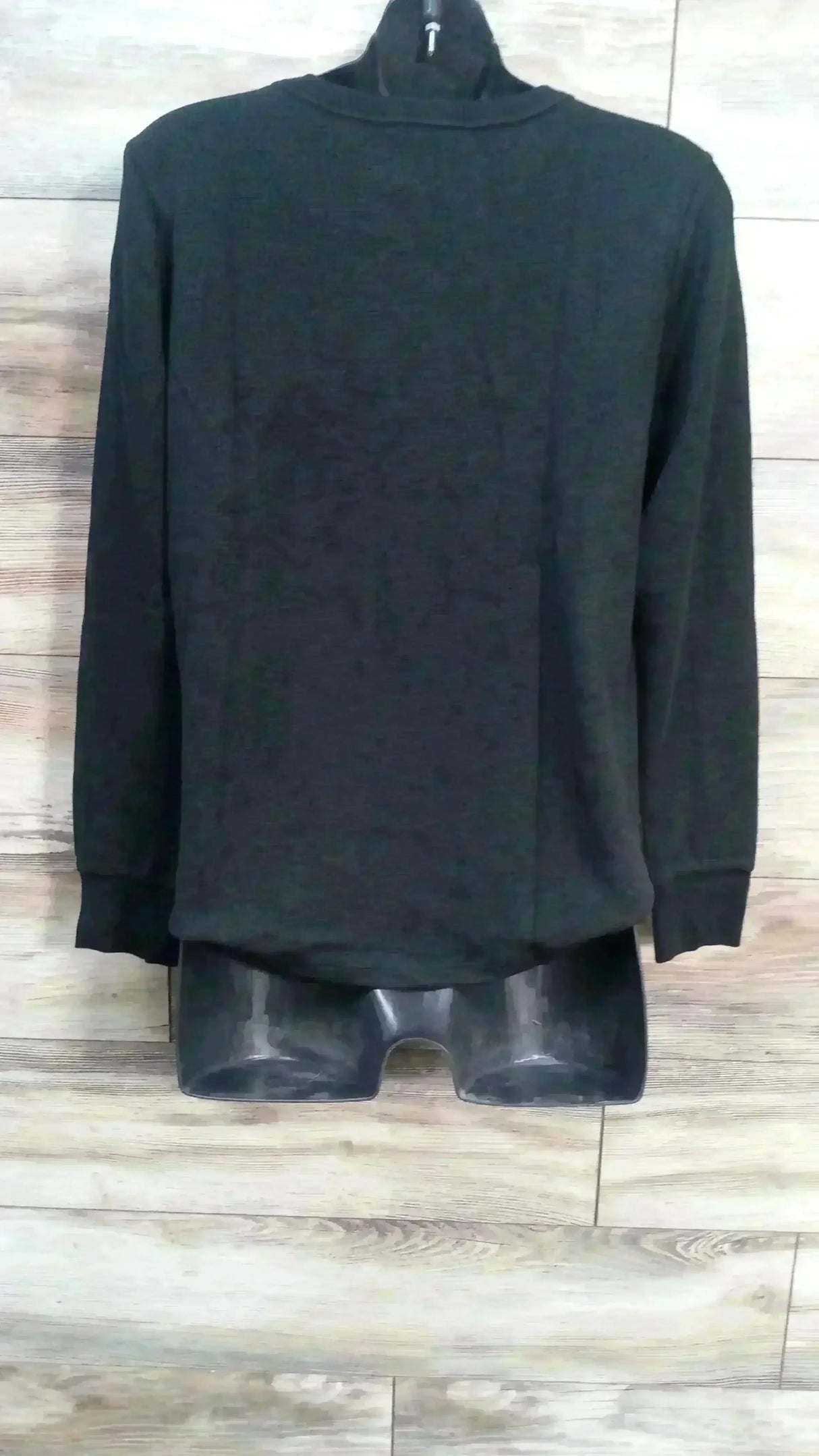 Back view of new Gap Maternity waffle-knit t-shirt in black with long sleeves on dress form over wood plank floor
