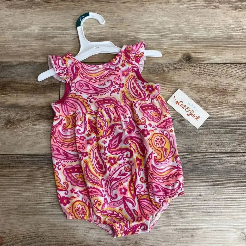 Flat lay of Cat and Jack paisley sunsuit (0–3 months) with ruffle cap sleeves and elastic leg openings on wood background