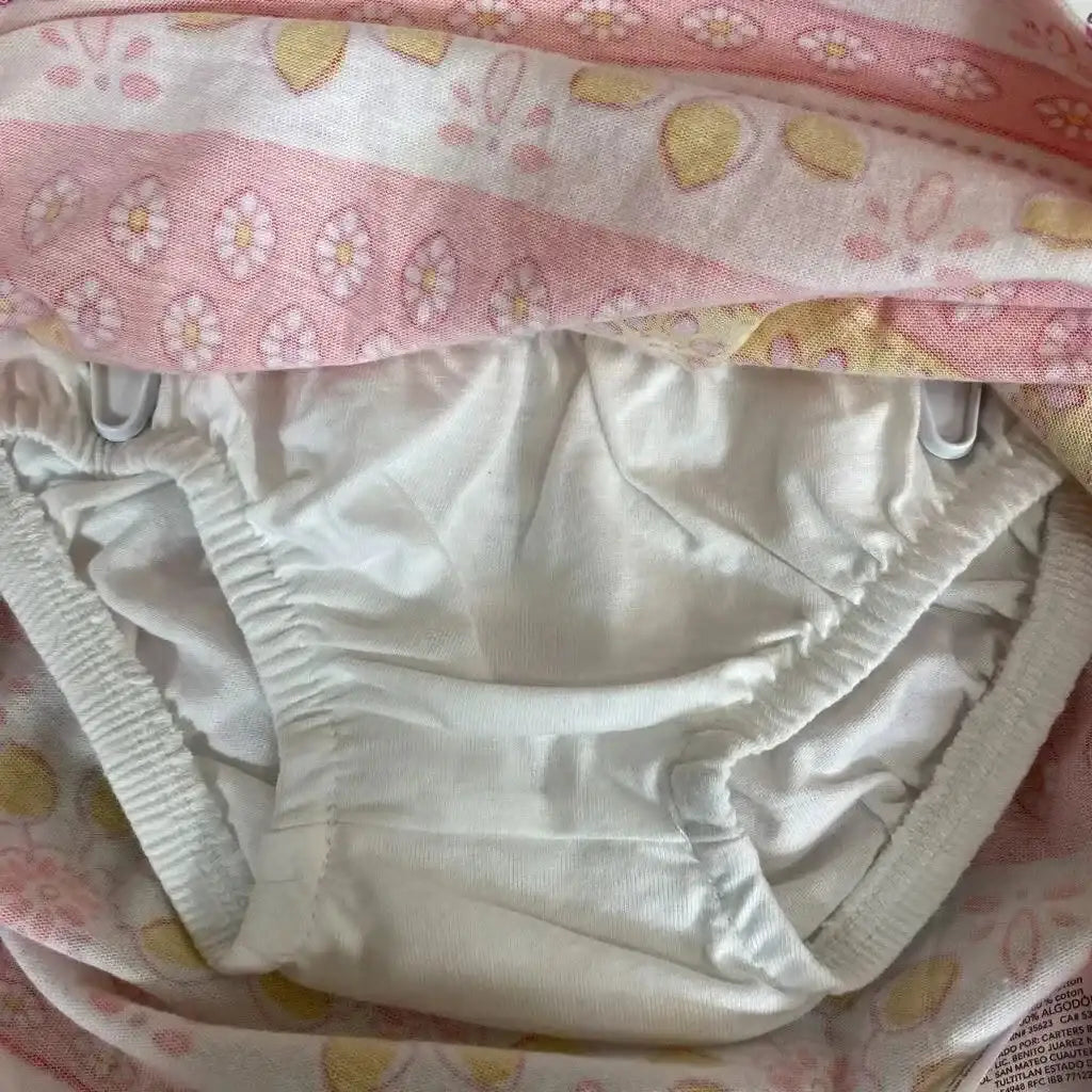 Close-up of Carter’s 2-piece dress and bloomers set showing white elasticized bloomers beneath pink floral fabric