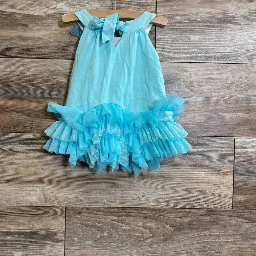 Front view of turquoise toddler ruffle tunic (18 months) showing layered tulle ruffle hem on wood floor background