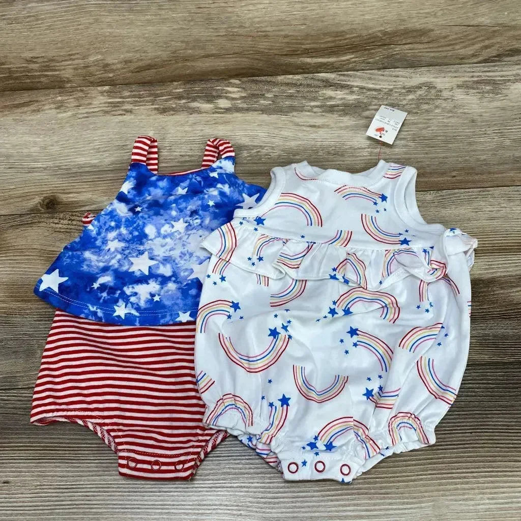 Front flat lay of Cat & Jack baby rainbow romper with white rainbow-and-star print, chest ruffle and snap crotch on wood background