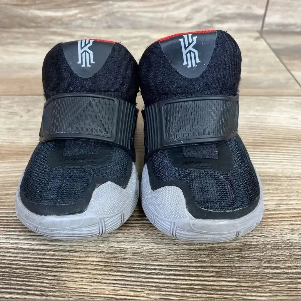 Front view of black toddler Nike Kyrie 6 sneakers size 4C showing Velcro strap closure and gray outsole on wood floor