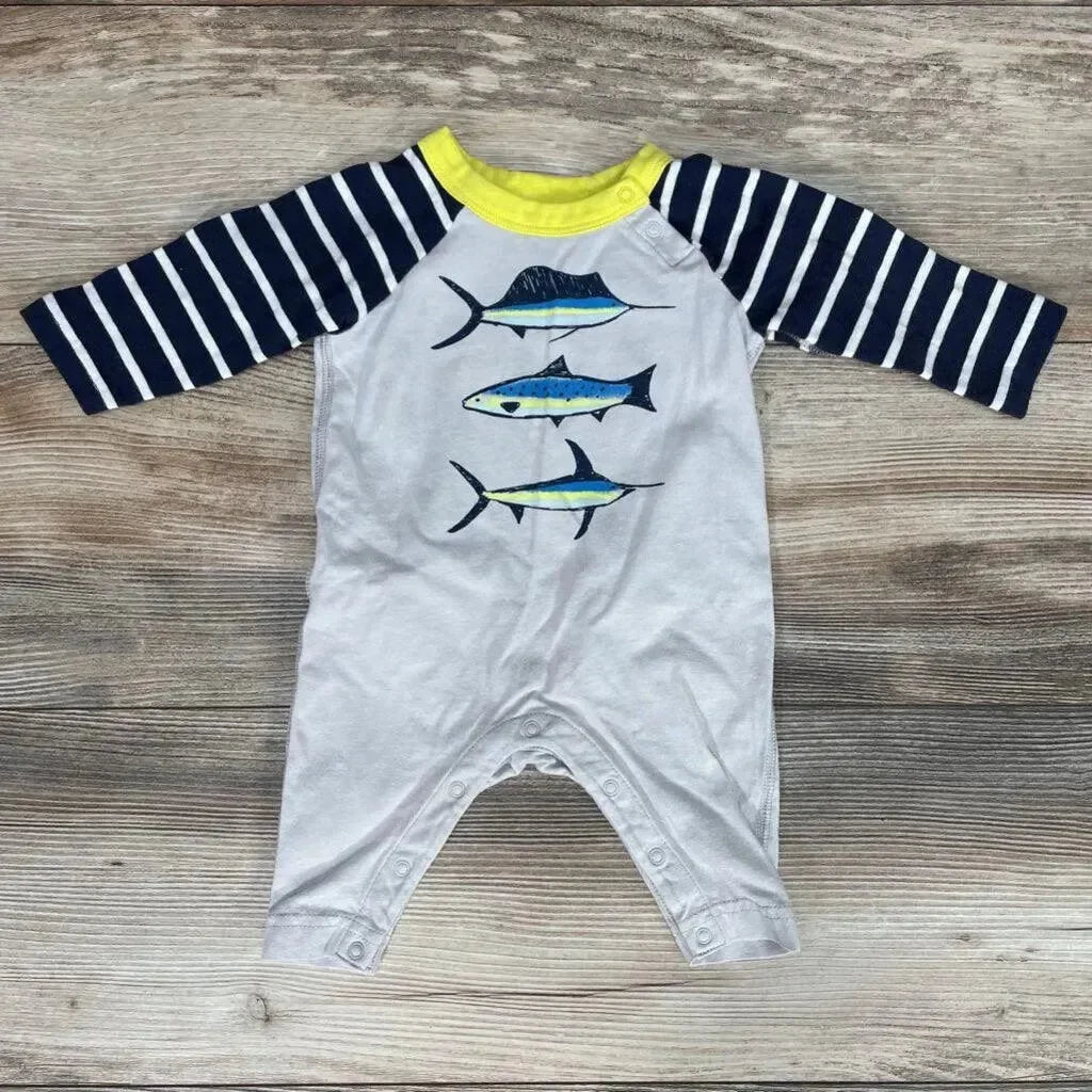 Flat lay of Tea Collection coverall (0-3M) showcasing navy-striped long sleeves, yellow collar, and three blue fish graphic on wood background