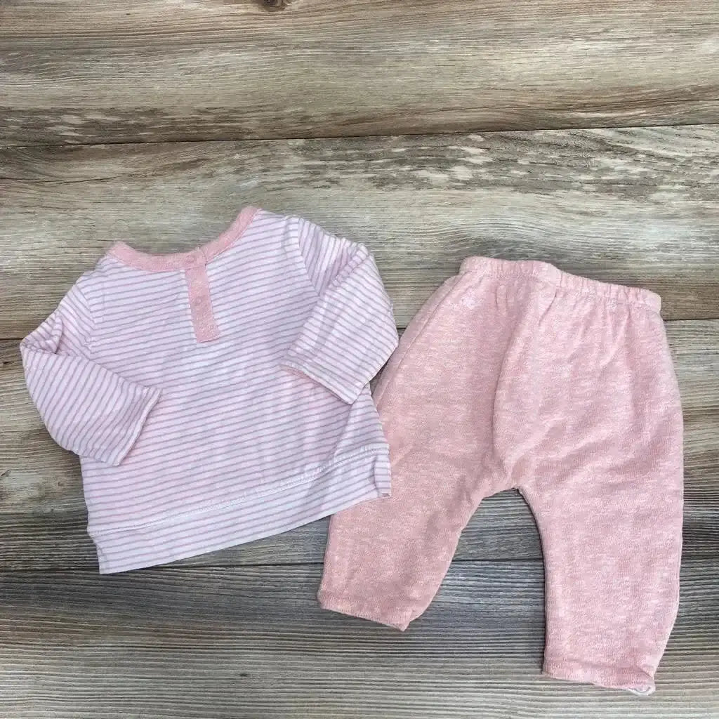 Flat lay of BabyGap 2-piece baby outfit size 0-3M: pink striped top and soft solid pink pants on wood background