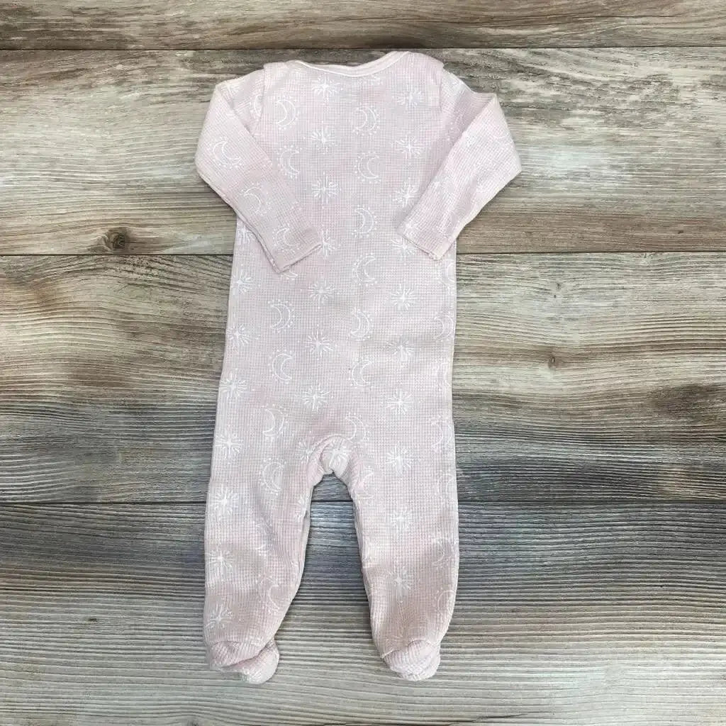 Flat lay of Rabbit Moon footed coverall in size 0-3m showcasing pink fabric, moon-star pattern, and footed legs on wood