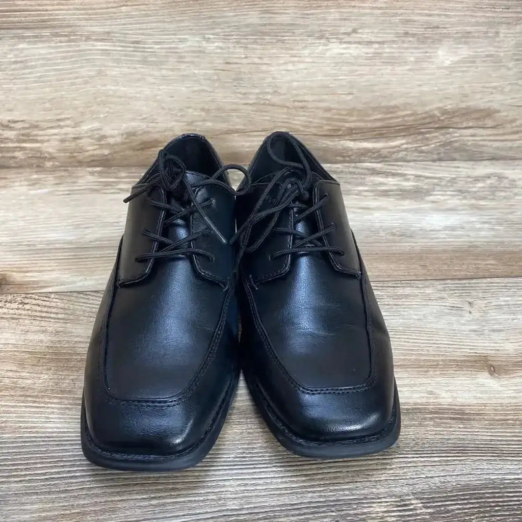 Front view of black Sonoma toddler dress shoes size 4Y showcasing lace-up vamp and square toe on light wood background