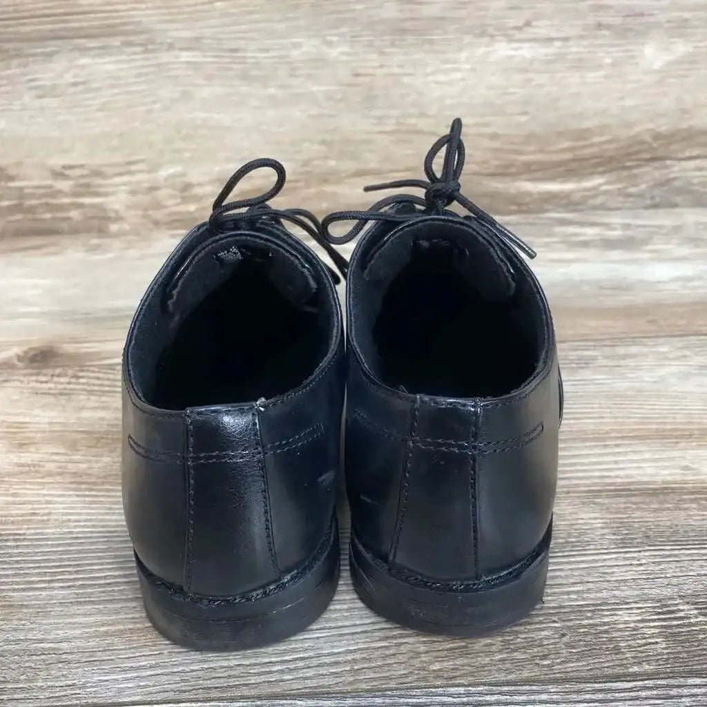 Side view of black Sonoma toddler dress shoes size 4Y showing lace closure, stitched toe and light scuff on white background