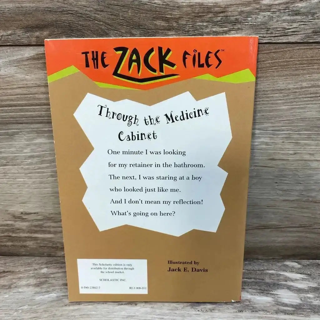 Back cover of Through the Medicine Cabinet paperback showing blurb and The Zack Files header on wooden background