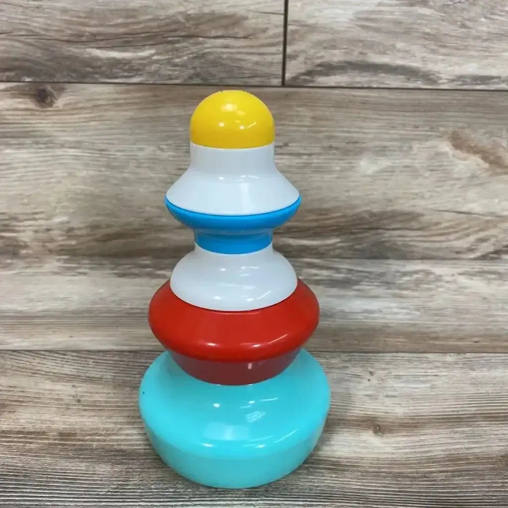 Front view of Kid O rounded stackers toy showcasing teal red white and yellow rings assembled with wood plank floor