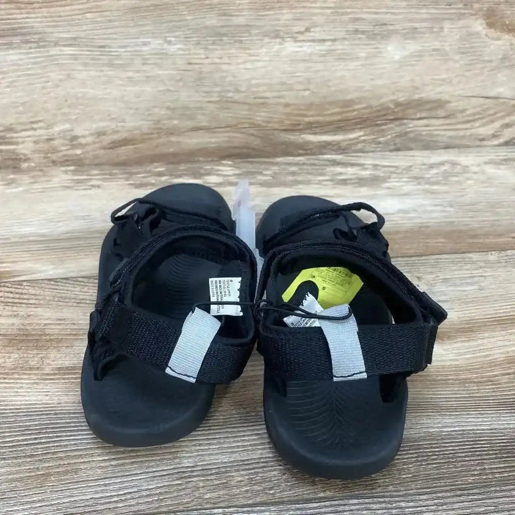 Back view of All in Motion Everest sandals, size 5Y, showing Velcro heel straps with gray tab and molded footbed on wood