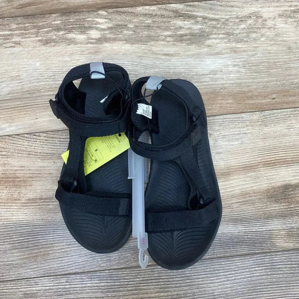Top view of black All in Motion Everest sandals size 5Y showing adjustable Velcro straps and textured footbed on wood floor