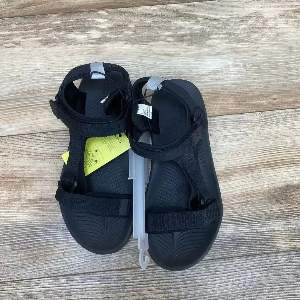Top view of black All in Motion Everest sandals size 5Y showing adjustable Velcro straps and textured footbed on wood floor