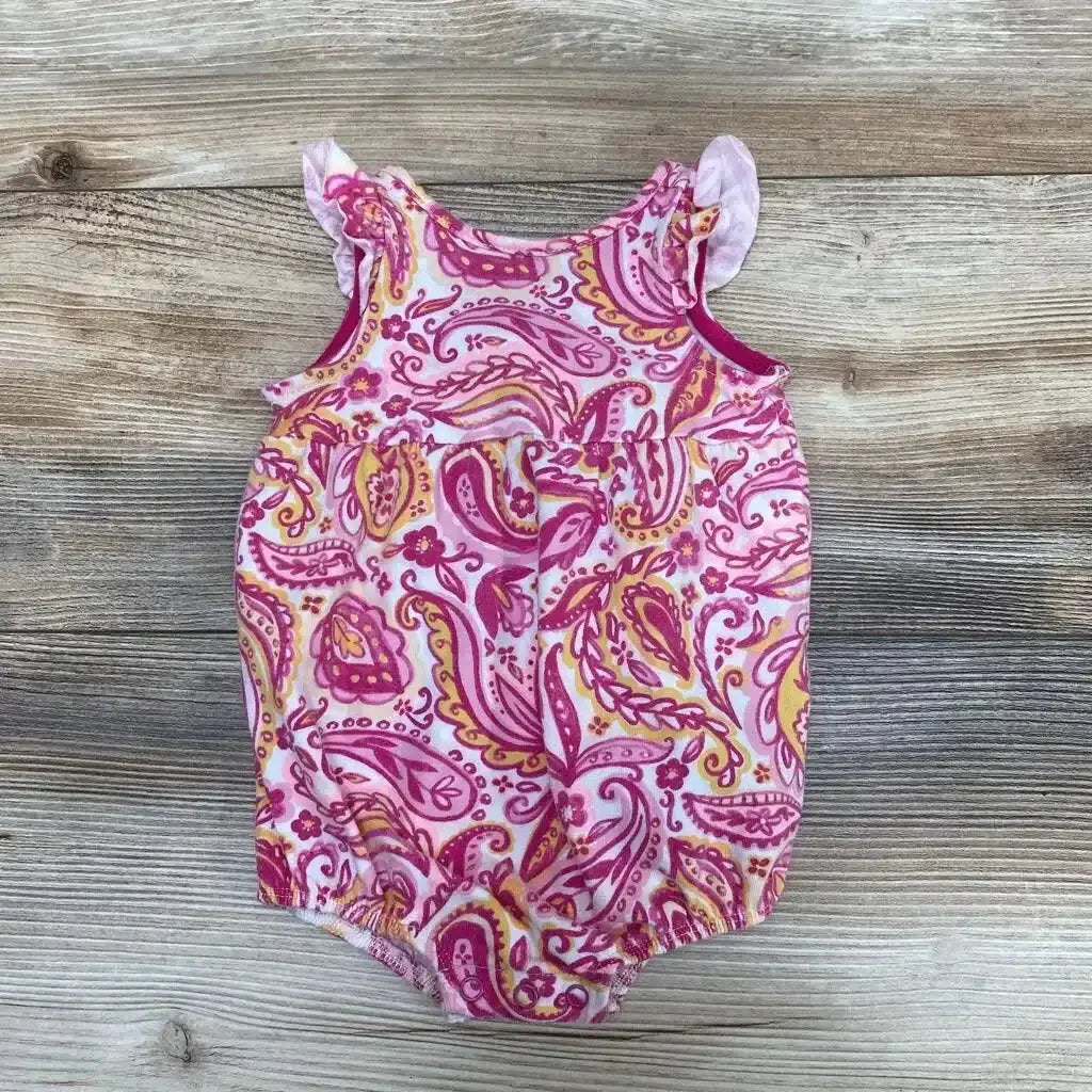 Top view of Cat & Jack Tank Paisley Romper sz 0-3m showcasing pink paisley print and ruffled shoulder straps on a wood-grain background