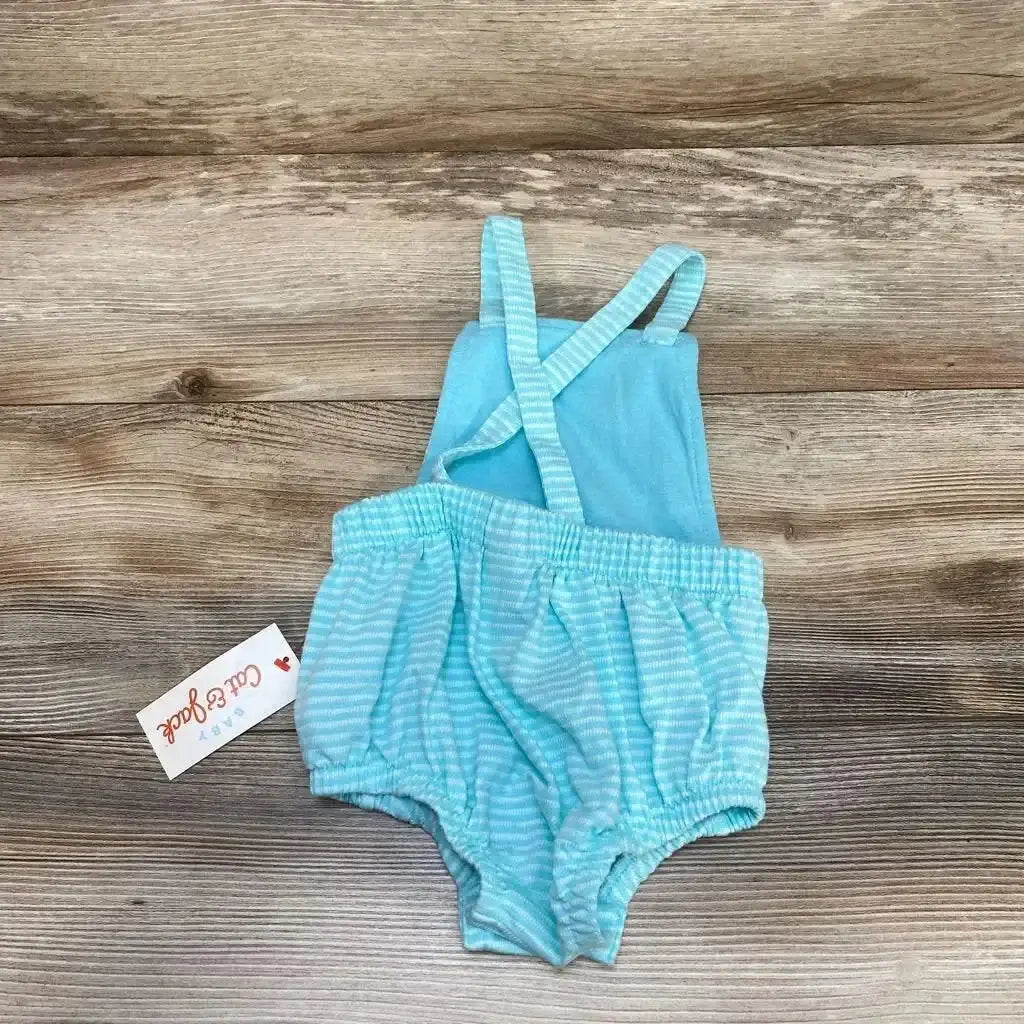 Back view of NEW Cat & Jack Textured Bubble Romper sz 12M showcasing aqua and white striped bubble bottom with criss-cross straps and hangtag on wood plank floor