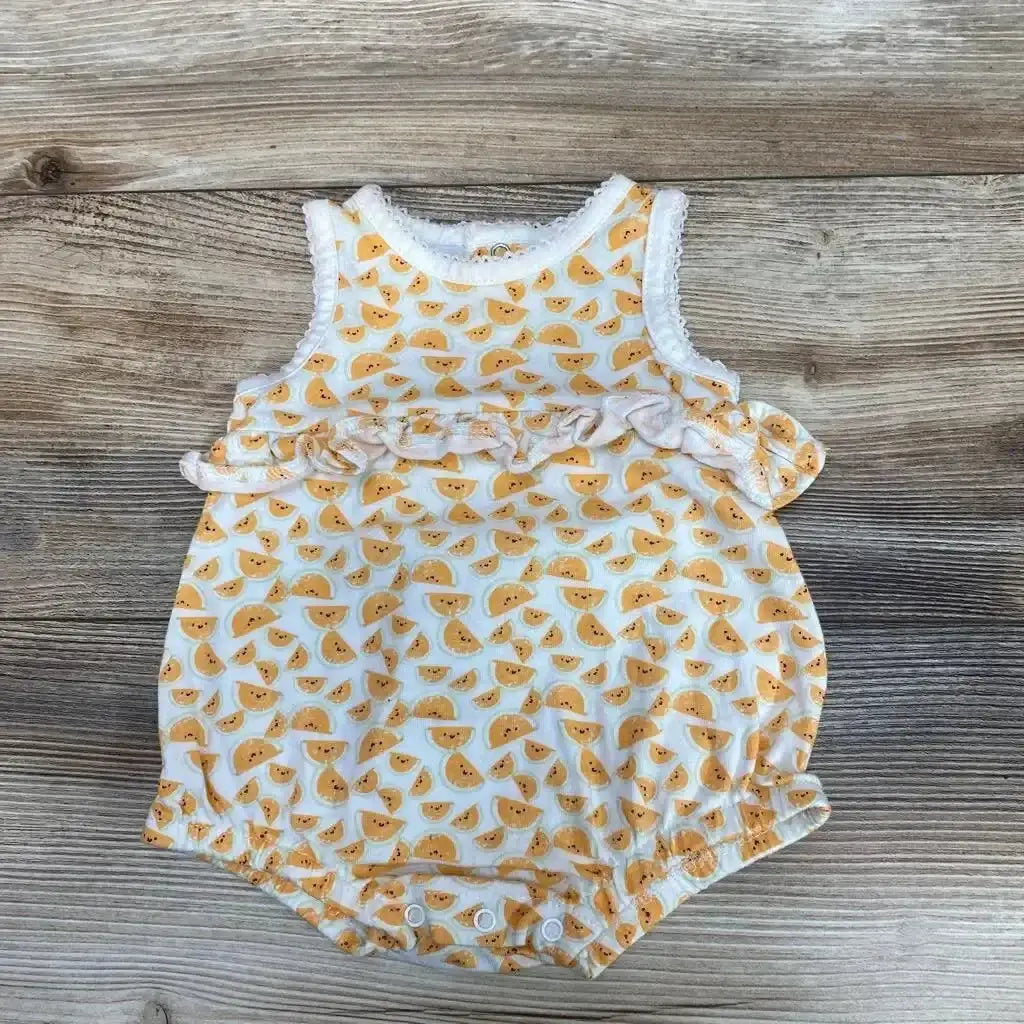 Front view of Starting Out Tank Shortie Romper sz 3m showcasing orange slice print, ruffled waist, and snap closures on wood background