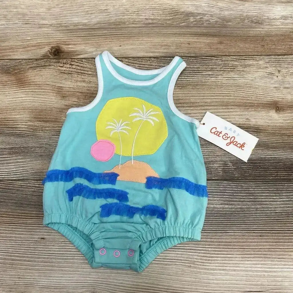 Flat lay of newborn Cat & Jack beach applique romper showing palm tree and island appliques and blue ruffle waves on wood