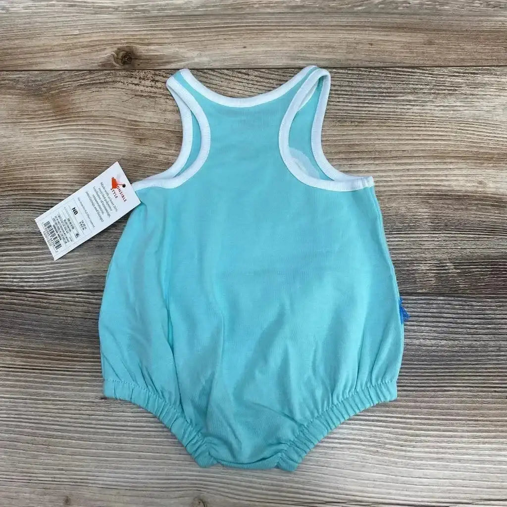 Flat lay of blue Cat & Jack newborn romper showing white-trim racerback and elastic leg openings on wood background