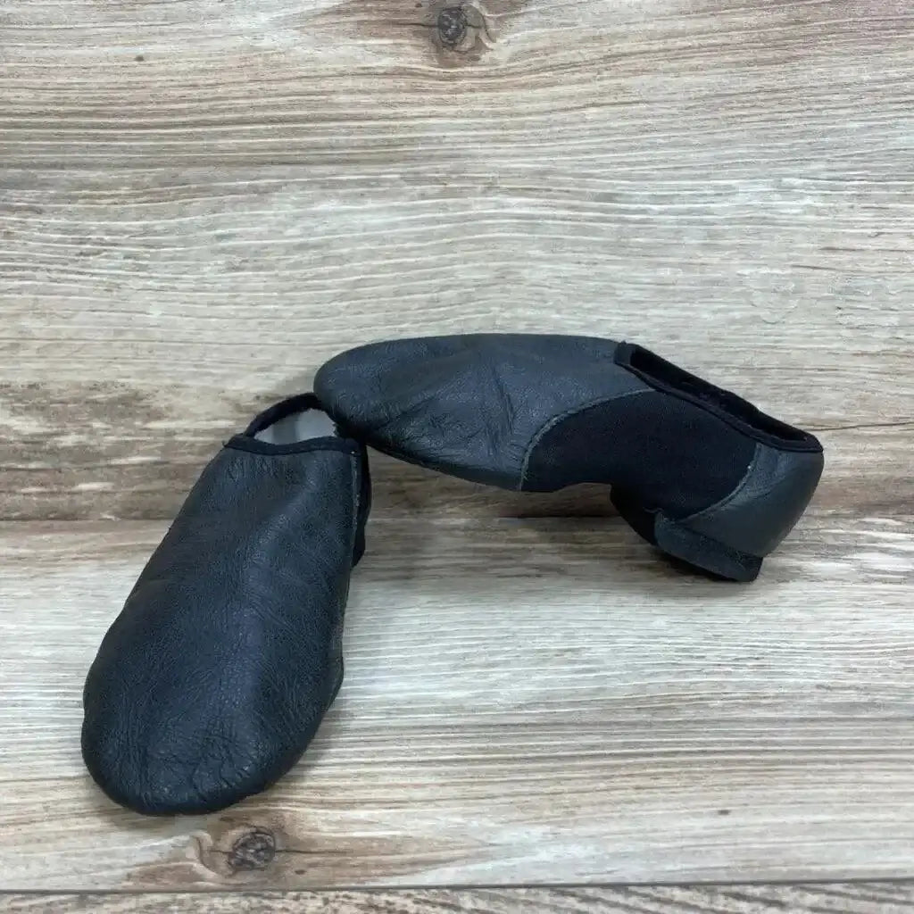 Front and side view of black Bloch Neo-Flex leather jazz shoes showing soft leather upper and elastic side panel on wood floor