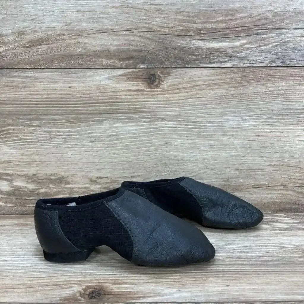 Side view of Bloch Neo-Flex leather jazz shoes with elastic side panels and low heel on light wood background