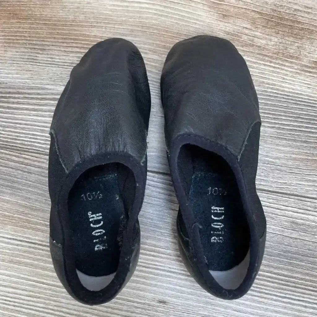 Top view of Bloch Neo-Flex Slip On Leather Jazz Shoes sz 10.5 in black with elastic gore and visible Bloch size label inside on wood plank floor